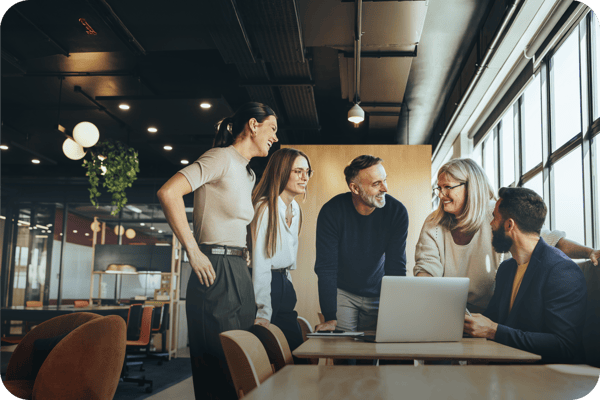 People looking and smiling at a computer