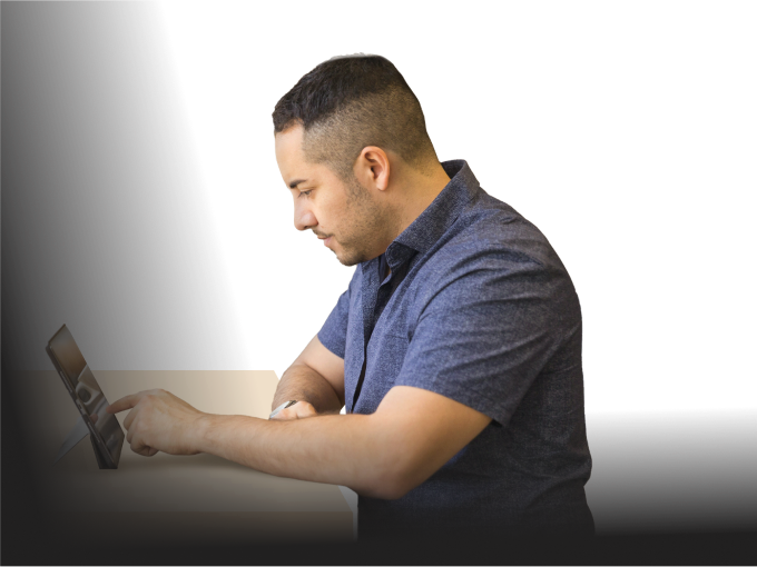 A man scrolling on his tablet